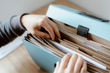Flexible folder with someone removing a papers