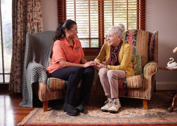 Elderly women talking to her female carer
