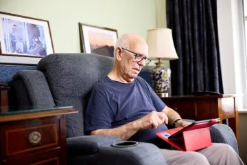 Elderly male resident room tablet phone