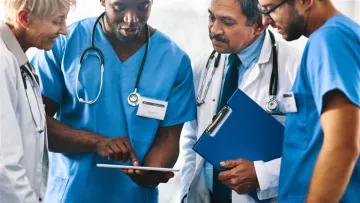 Thumbnail: GPs looking at a tablet. Calculating the Medicare BBPIP