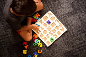 A child playing with a puzzle board