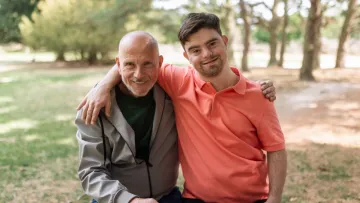 A carer and their care recipient in the park
