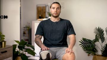 Seb sitting on a chair speaking to the camera