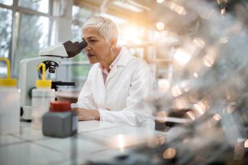 Older female researcher at work in lab