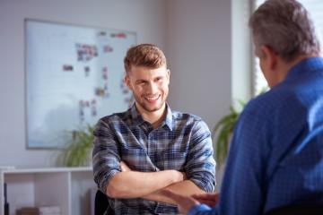 Image of male talking with another male