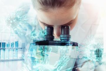 Female researcher using microscope