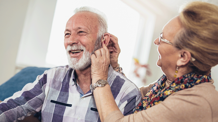 Older couple with hearing aid