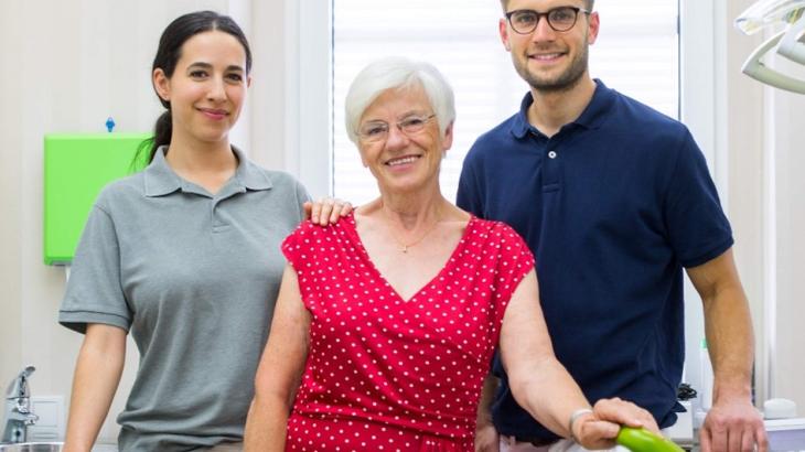An image of two aged care workers with an older lady