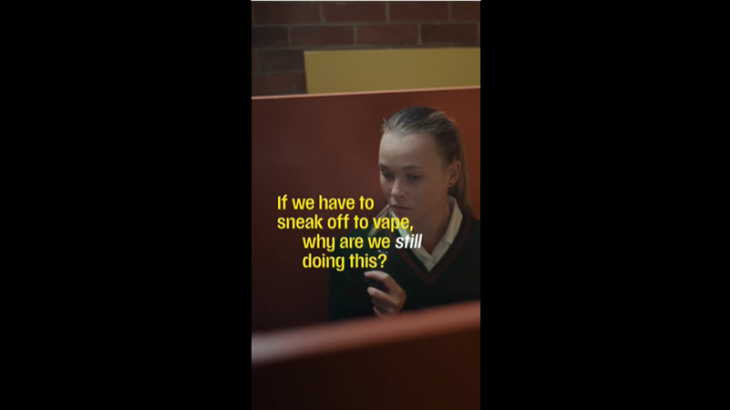 Girl vaping in a toilet stall