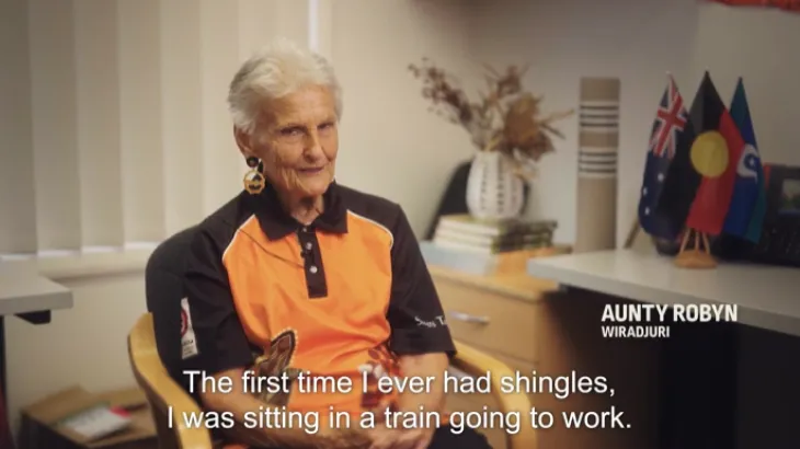 Elderly women sitting in a chair talking about her experience with shingles