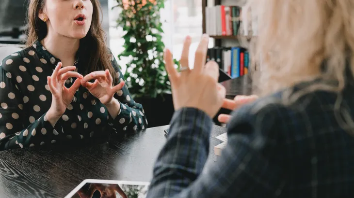 Photographic image of 2 women signing in Auslan