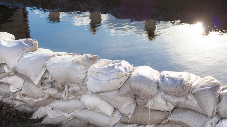 An image of sandbags holding back water