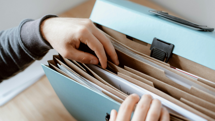Flexible folder with someone removing a papers