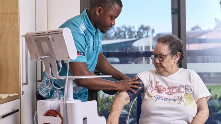 A care worker assists an elderly resident