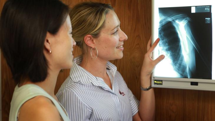 Two medical officers looking at an xray