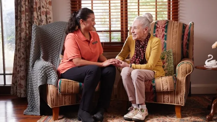 Elderly women talking to her female carer