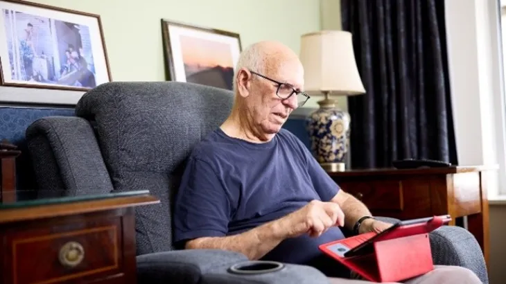 Elderly male resident room tablet phone