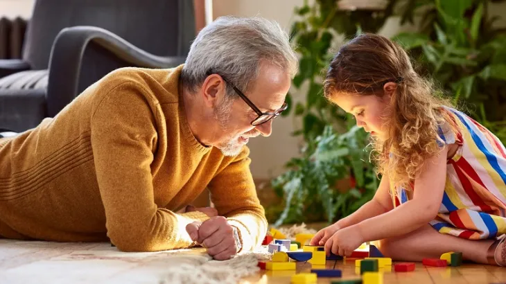male father with his young daughter playing with blocks