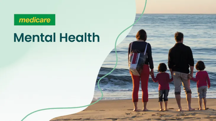 Medicare card and family standing on a beach