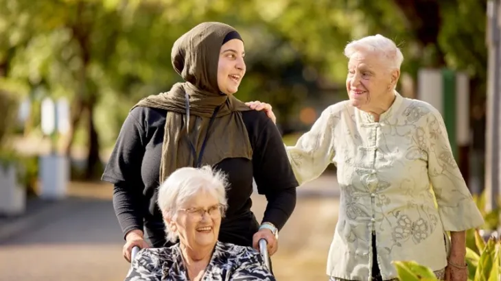 Female Residents and RN walking outside