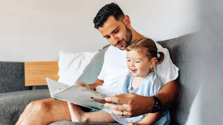 A father and child reading a book
