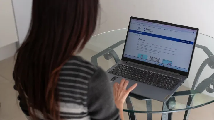 Leanne is a Carers looking at her laptop for Carers Gateway