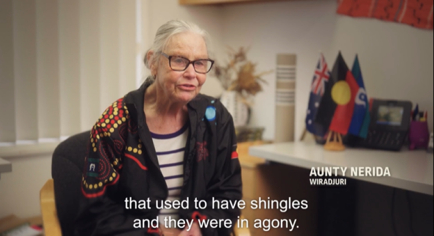Elderly lady in chair being interviewed about her experience as a nurse and having patients with shingles