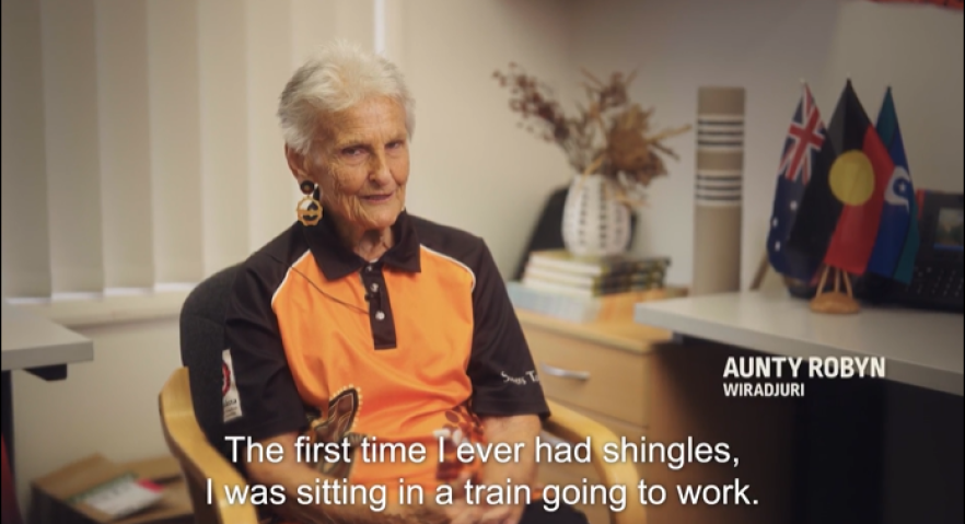 Elderly women sitting in a chair talking about her experience with shingles