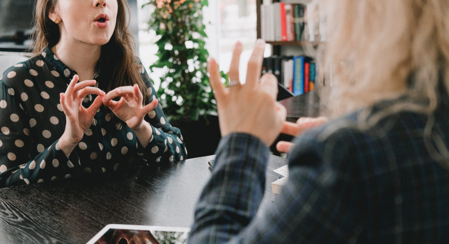 Photographic image of 2 women signing in Auslan