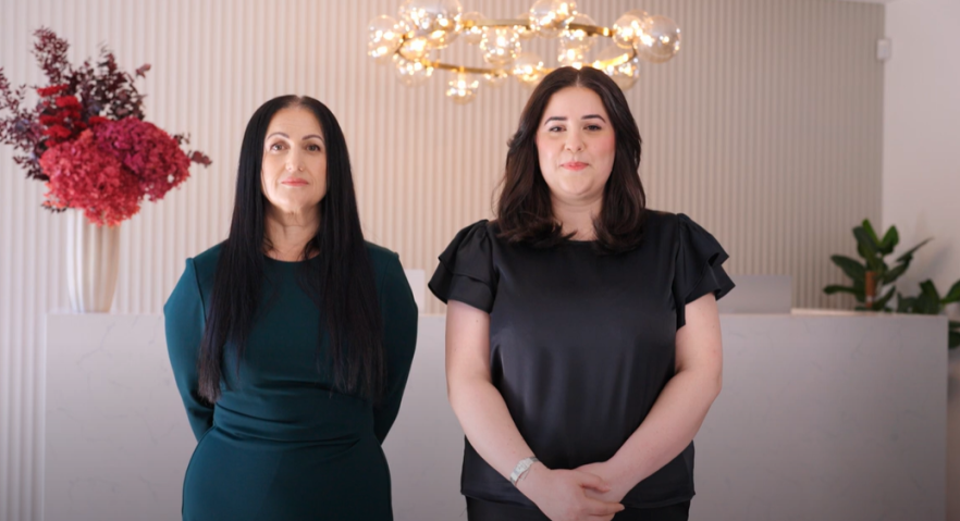 Screen capture from video with two women standing