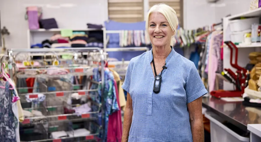 Image of an elderly woman at a charity shop