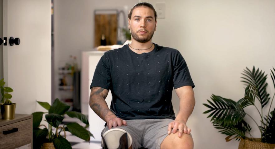 Seb sitting on a chair speaking to the camera