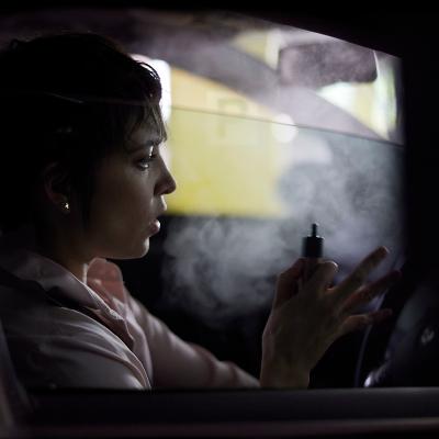 Woman vaping in a car