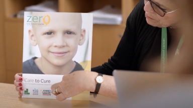 Doctor points to Zero Childhood Cancer brochure