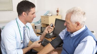 Doctor consulting with older male patient 